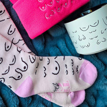 Load image into Gallery viewer, Pair of socks with a pattern on a blue textured surface