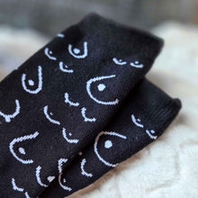 Load image into Gallery viewer, Black socks with white pattern on a soft surface