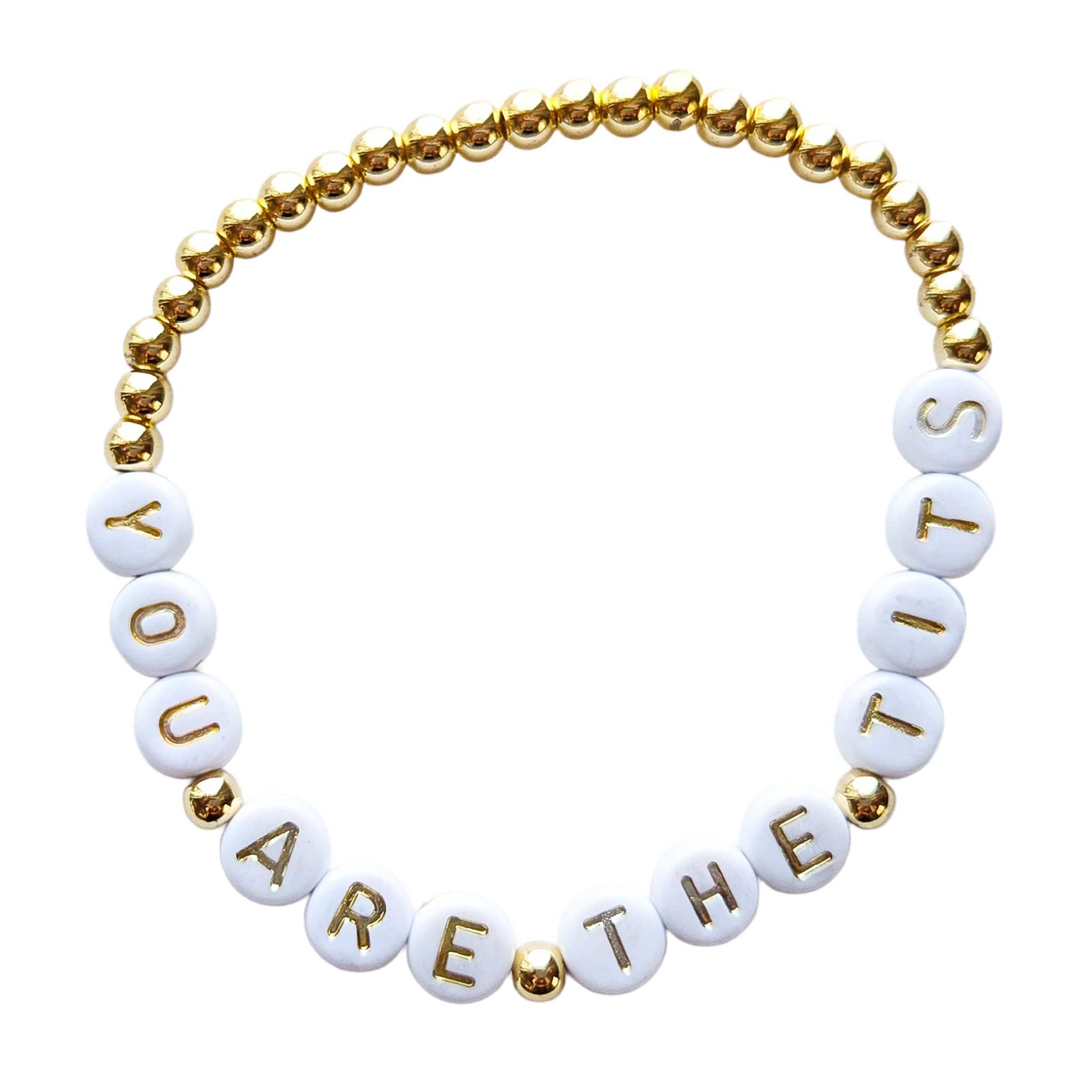 Bracelet with gold and white beads spelling out 'YOU ARE THE TITS' on a white background