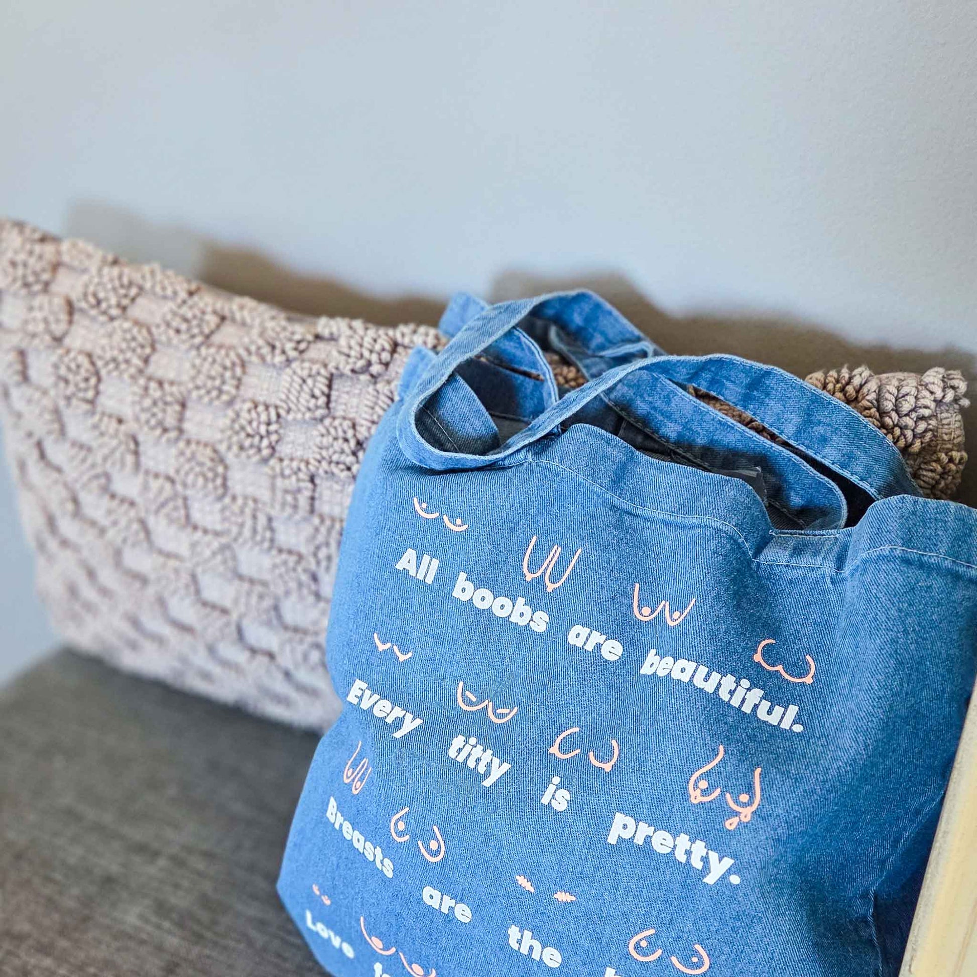 Blue denim bag with text and designs on a textured surface