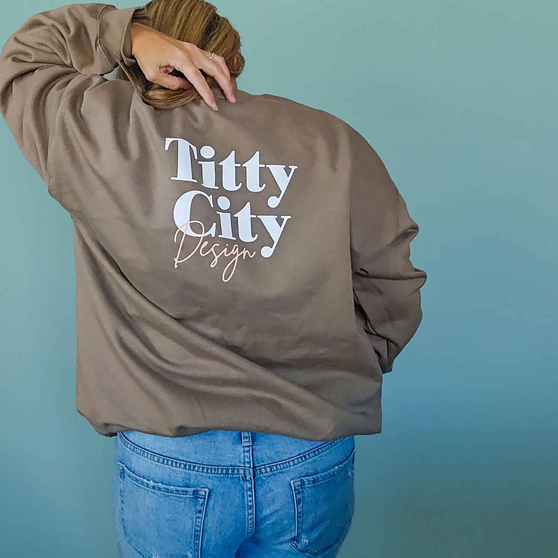Model wearing the Body Positivity crew sweatshirt in coffee brown, back view