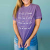 Close up of model wearing the Body Positivity T-Shirt in plum purple, front view, styled casually with jeans 