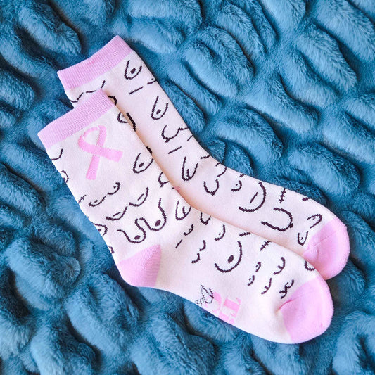 Pair of socks with pink accents and text on a textured blue surface