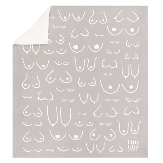 Gray blanket with white abstract pattern and 'Titty City' branding