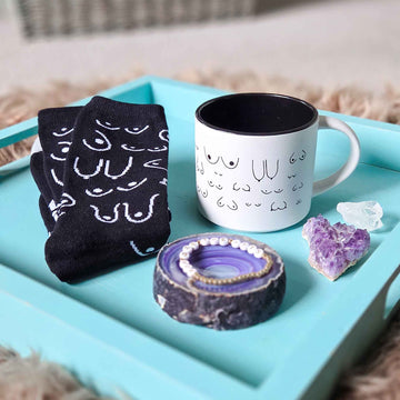 mug, socks, and bracelet styled on an aqua tray with amethyst and quartz