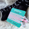 Tilties hair ties with a branded card on a textured surface