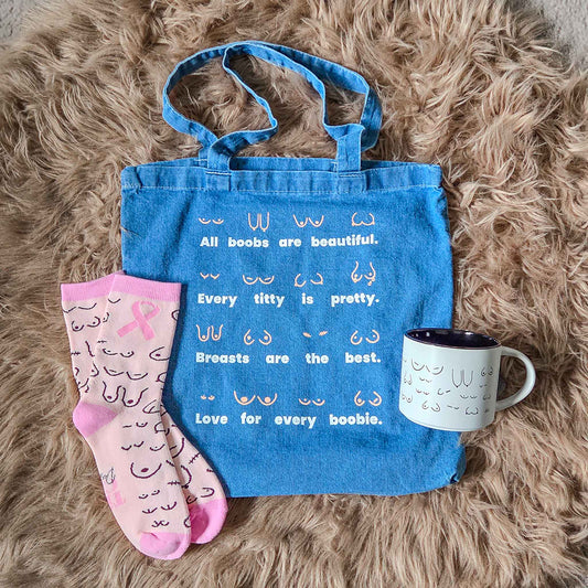 Blue tote bag with text, pink socks, and white mug on a fluffy brown surface