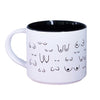 White mug with black interior and decorative black patterns on a white background