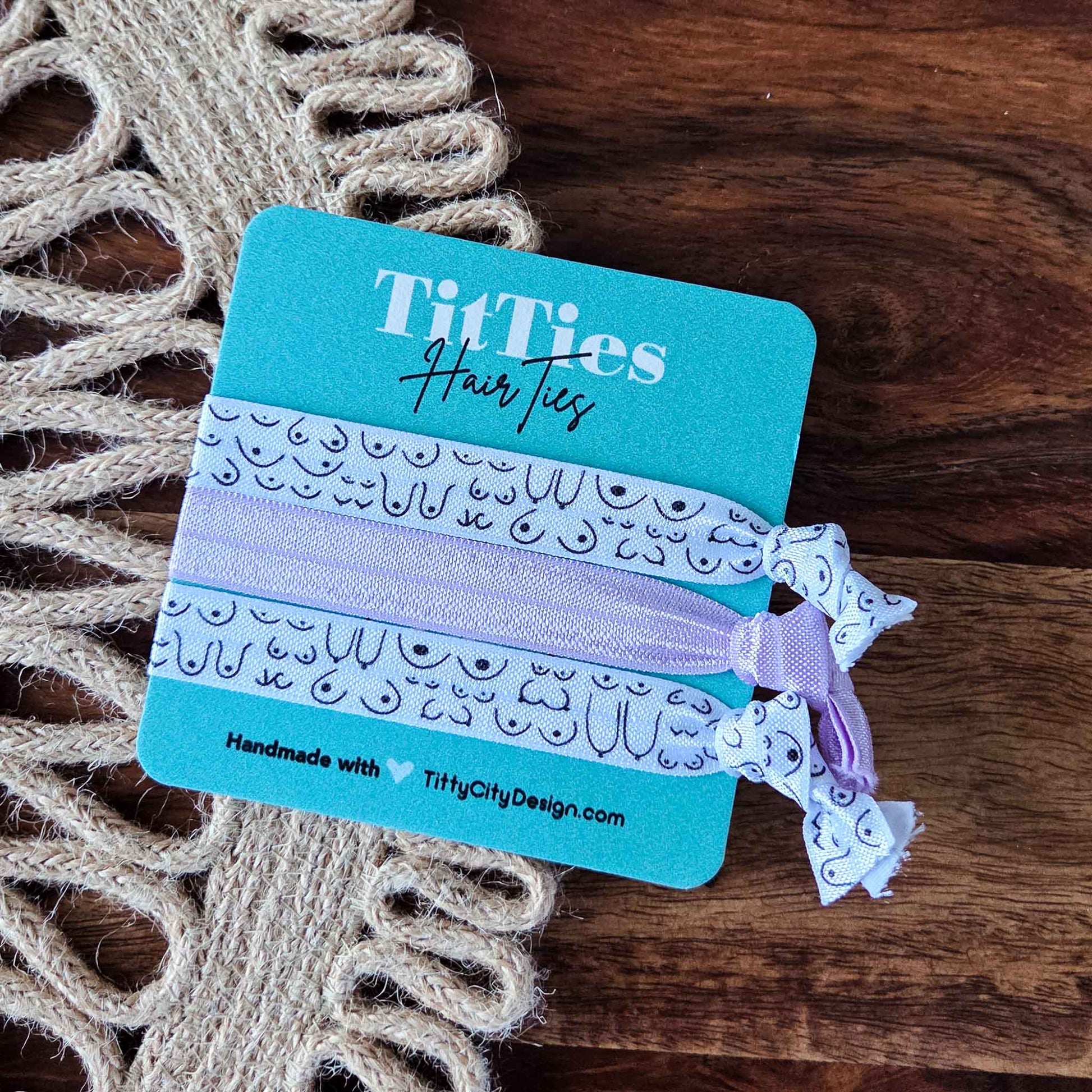 TiffTies hair ties on a branded card with decorative elements on a wooden surface