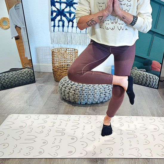 Person practicing yoga on a mat in a home setting